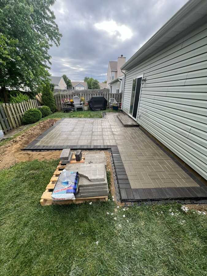 After: new paver patio with charcoal border and entry step
